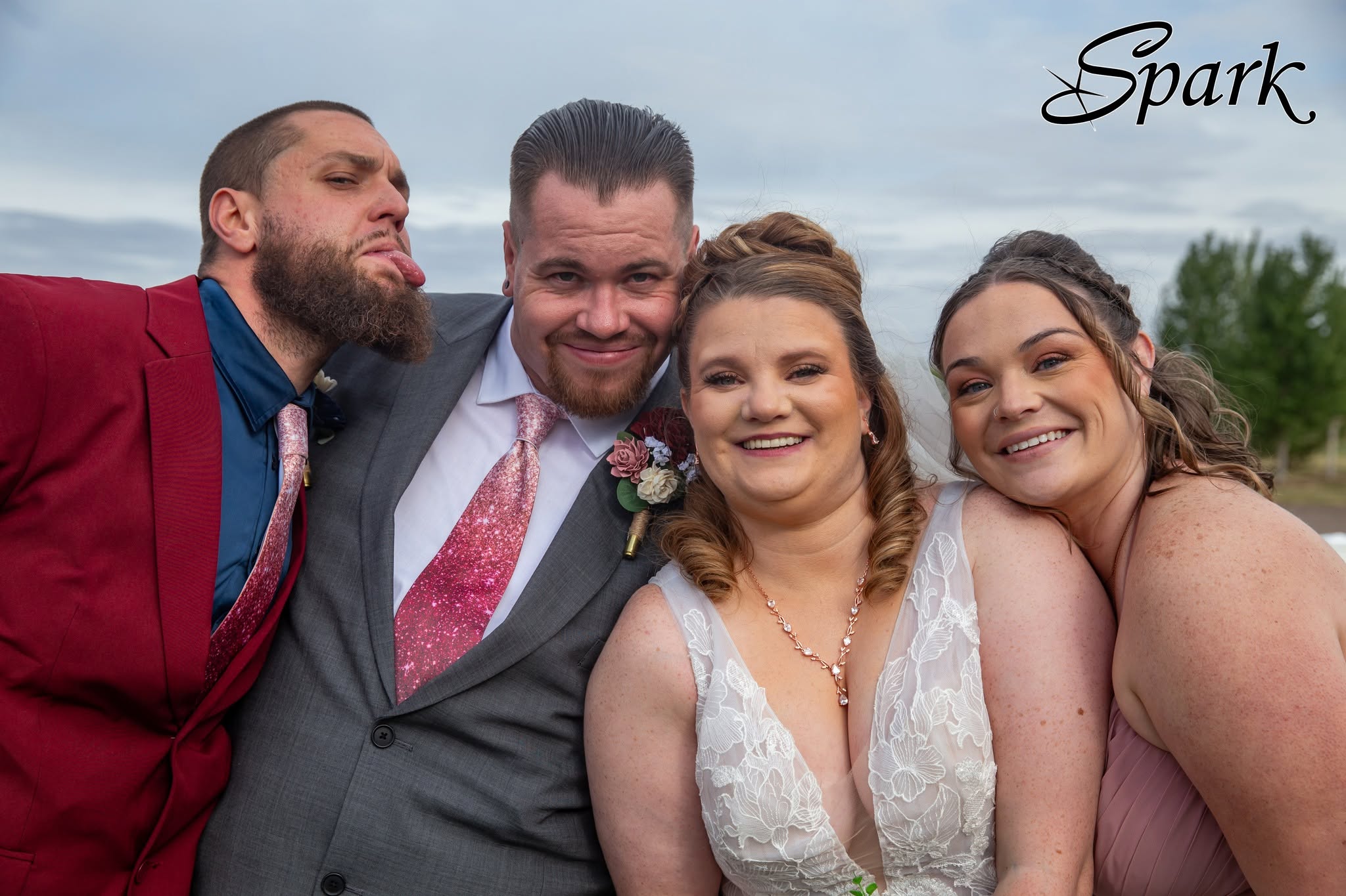 Wedding party sharing a playful portrait outdoors