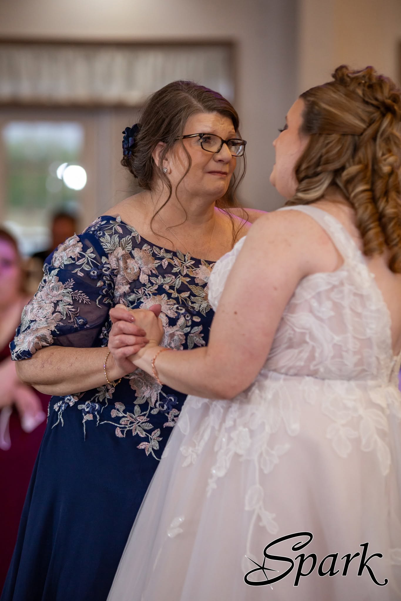 Bride sharing an emotional dance with a guest