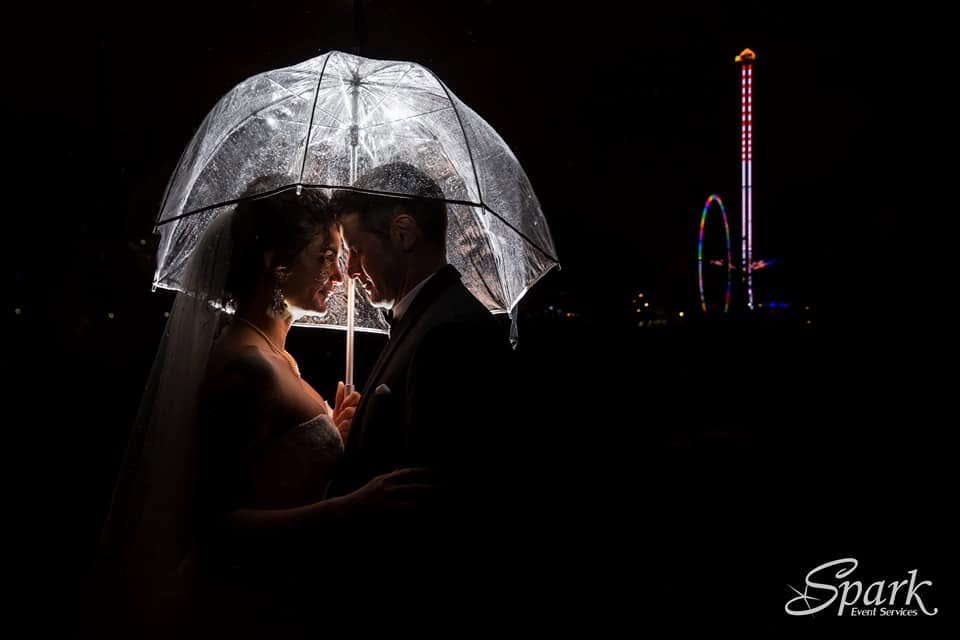 Bride and groom beneath an illuminated umbrella at their Denver wedding